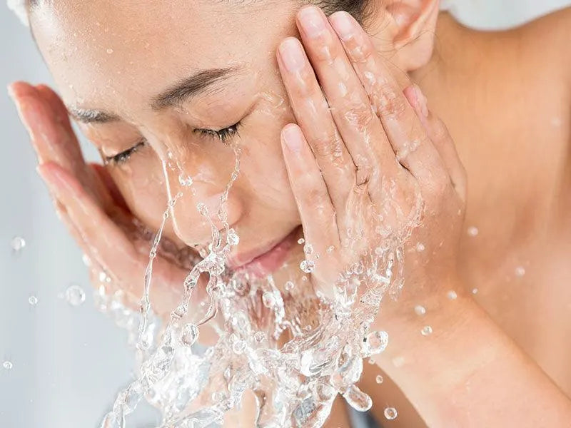 Woman washing her face with gentle Ayurvedic facewash for glowing skin