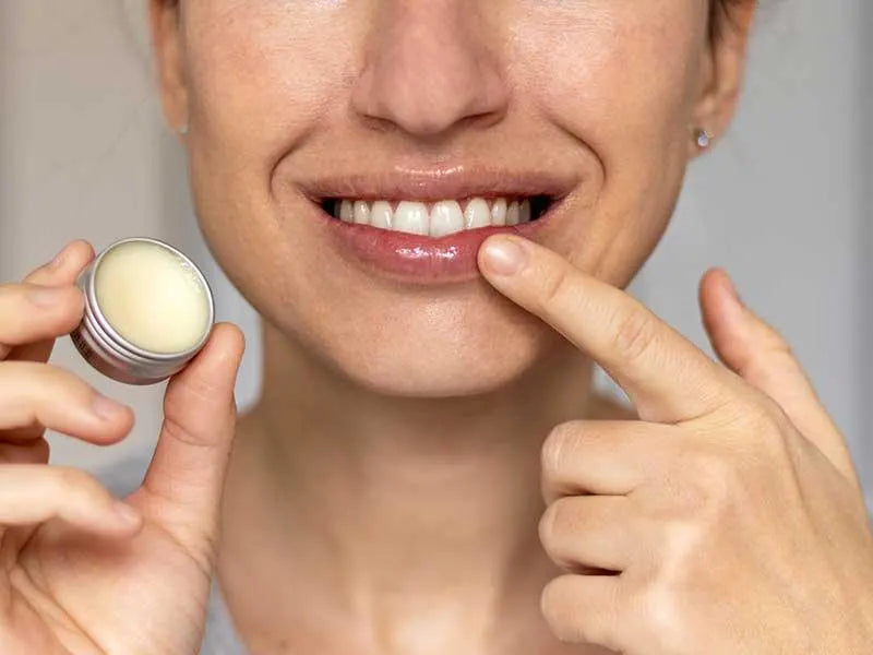 Applying Kumkumadi Lip Balm for smooth and nourished lips
